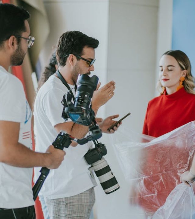 Behind-the-scenes look at a professional photoshoot setup with models and photographers.